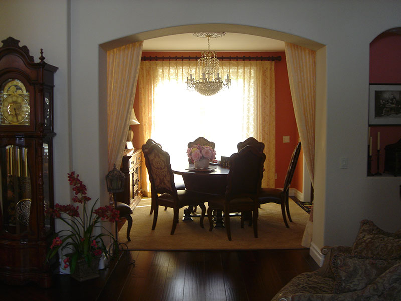 Fabric softens the archway in the formal dining room in Corona, CA