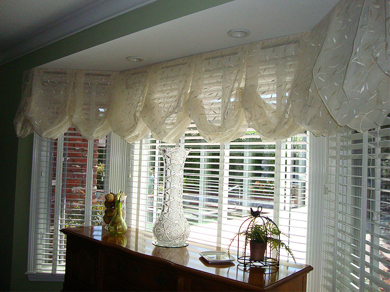 Elegant curtains and blinds frame a marvelous view