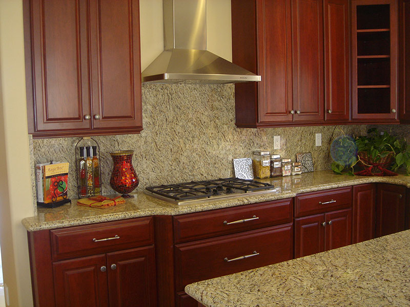 Cherry cabinettes and granite countertops enhance this warm inviting kitchen
